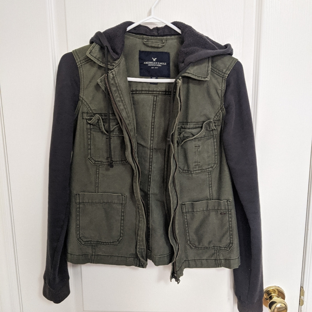 Army green jacket with sweater layering detail